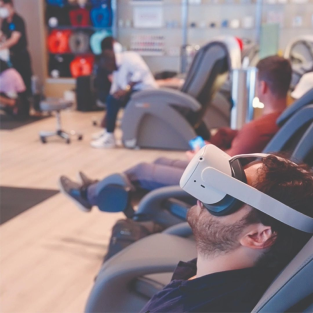 People sitting, wearing VR goggles